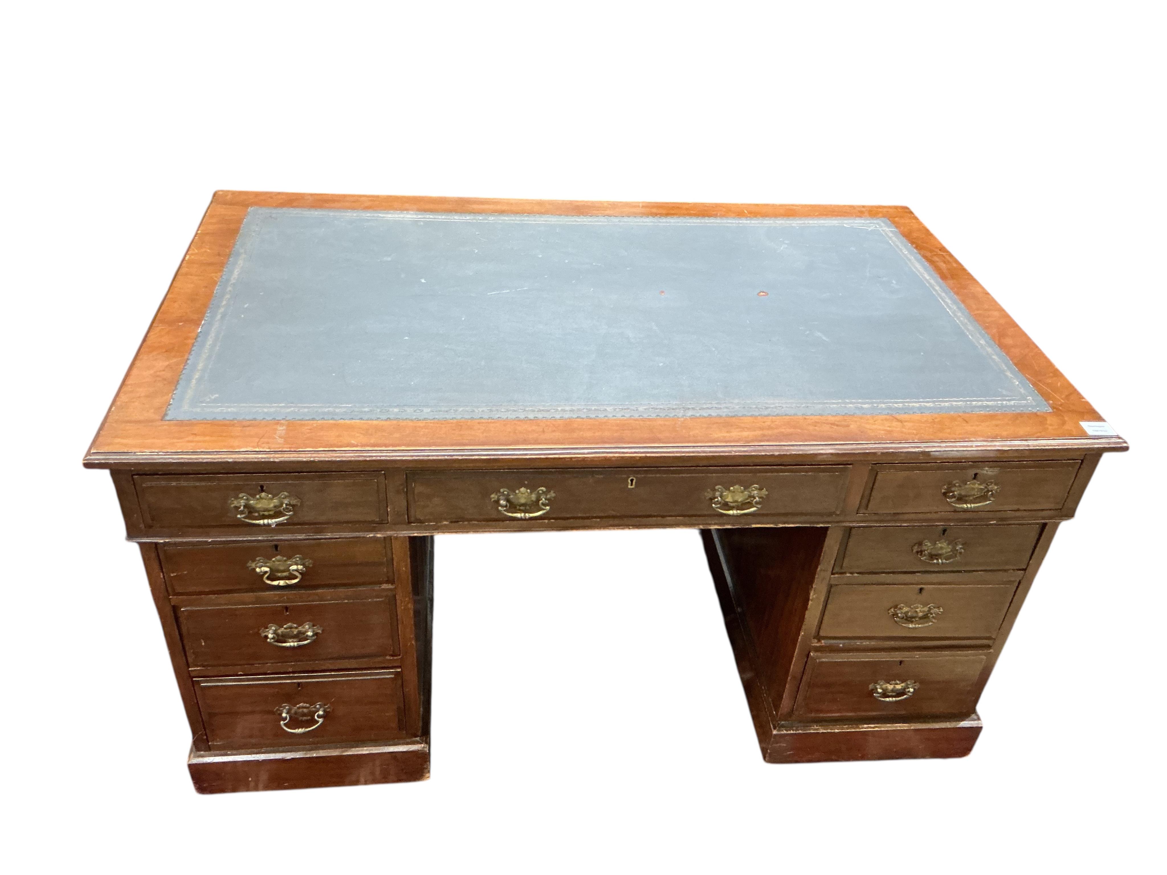 A late Victorian mahogany pedestal desk, fitted nine small drawers, width 138cm, depth 82cm, height 74cm